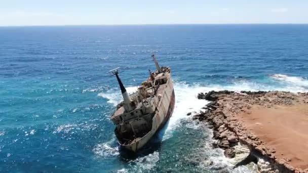 Video van bovenaf. Luchtfoto van de zeekust. Vliegen over de kustlijn met gebroken schip. Middellandse Zee en de kust. Schieten vanaf de drone. Cyprus. — Stockvideo