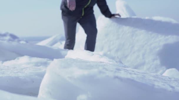 知られていない男は寒い冬の天候で氷河の頂上に登った。スローモーション. — ストック動画