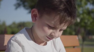 Açık havada sevimli bir gülümseyen çocuk portresi. Sevimli çocuk yaz parkında zaman harcamak.