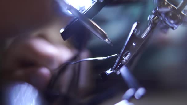 Close-up working with a soldering iron at workshop. Concept of the profession, accurate work, engineer position. — Stock Video