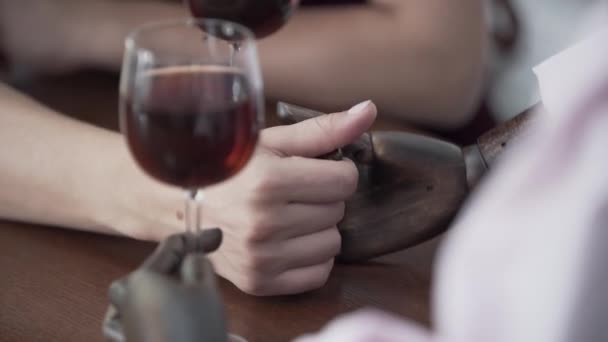 Gros plan main de femme assise à la table buvant du vin rouge avec un mannequin masculin imitant la date avec le vrai homme. Femme touchant la main de la poupée. Concept de rêve, imagination, solitude — Video