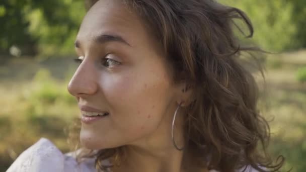 Close-up portrait of positive young woman with curly hair looking away and at the camera. Rural life. Retro style. Country girl enjoying beautiful summer day — Stock Video