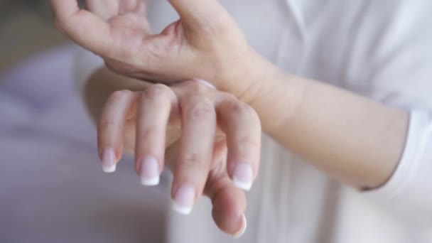 Primer plano de mujer madura con manicura francesa aplicando crema de manos blanca en sus manos. Cuidado corporal, concepto de cuidado de la piel. Crema anti-edad usando — Vídeos de Stock