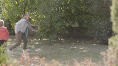 Neşeli beyaz kadın ve sonbahar parkında çalışan küçük sevimli kız. Anne kızı ile hafta sonları harcama.