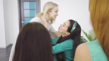 Genç beyaz sarışın kız hamile esmer arkadaşı sarılma ve menekşe hediye çantası ona hediye veren. Dört büyüleyici kadın beklentisi ile vakit geçiriyor.