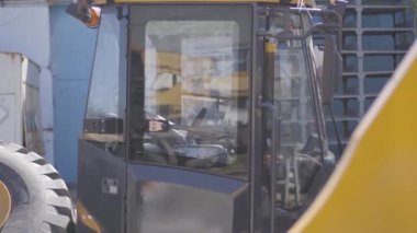 Traktör kabininin yan görüntüsü. Endüstriyel aracın güneş ışığı altında dışarıda durduğu yakın plan. İnşaat, üretim, endüstri.