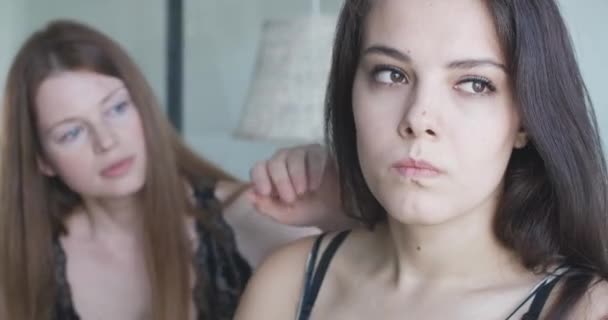 Close-up of furious lesbian woman with angry facial expression looking back at partner trying to calm her down and turning back to camera. Portrait of Caucasian young argued couple. Cinema4k ProRes HQ — Stock Video