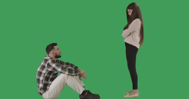 Wide shot of daughter and father arguing at chromakey background. Caucasian man sitting as teenage girl standing and gesturing no by shaking head. Disagreement, adolescence. Cinema 4k ProRes HQ. — Stock Video