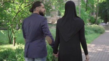 Romantik Müslüman bir çiftin parkta yürüyüp konuşması. Kamera, takım elbiseli sevimli sakallı adamı ve güneşli yaz gününde tesettürlü genç kadını ara sokakta dolaşırken çeker. Çıkma, aşk, aşk