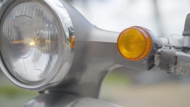 Extreme close-up of retro scooter headlight. Vintage road vehicle standing outdoors on cloudy day. — Stock Video