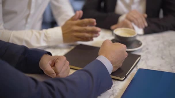 Unrecognizable angry male CEO hitting table with clenched fist and gesturing. Dissatisfied manager scolding employees in office or in cafe. Business problems concept. — Stock Video