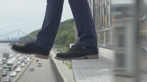 Vista lateral de primer plano del hombre de negocios fracasado que intenta suicidarse. Hombre suicida irreconocible de pie en el puente con coches borrosos a lo largo de la carretera. Frustración y depresión. — Vídeos de Stock