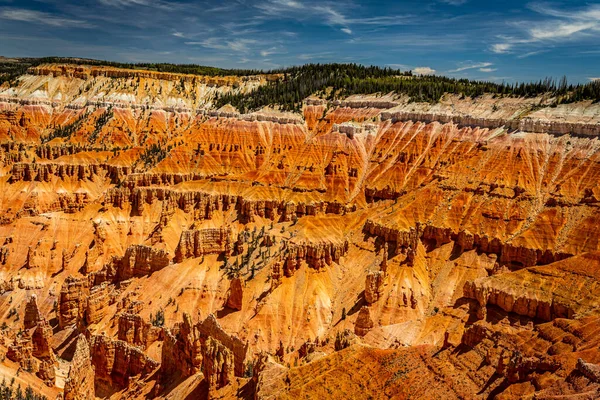 Cedar Breaks National Monument is a natural amphitheater canyon at an elevation of ten thousand feet stretching three miles wide and over a half mile deep near Cedar City, Utah.