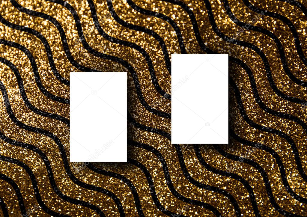 The business card mock-up template with gold glitter wavy line pattern fashion dark paper background