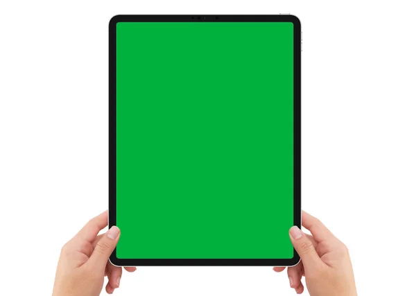 Isolated human left hand holding black tablet with green screen — Stock Photo, Image