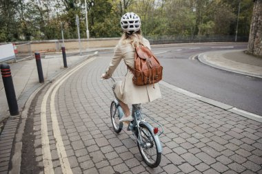 İşe giderken sokakta Bisiklete binme unrecognisable bir kişinin arka görünümü.