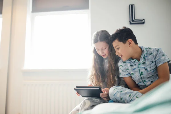 Niña Hermano Están Mirando Una Tableta Digital Juntos Dormitorio Del —  Fotos de Stock