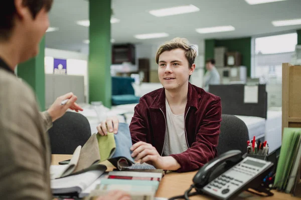 Young Man Discussing Fabric Swatches Sales Clerk Furniture Shop — Stock Photo, Image