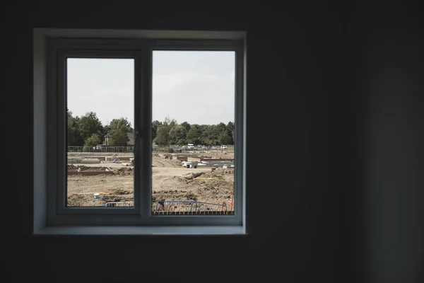 View outside of a home window of a construction site.