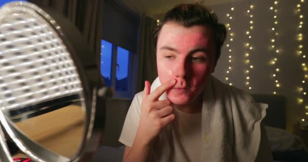 Young Man Applying Face Mask Home — Stock Video