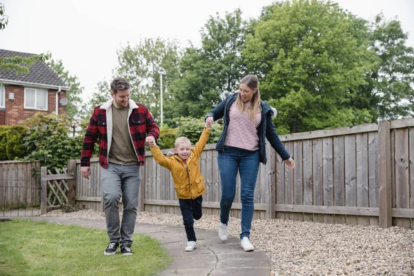 Menino Segurando Mãos Seus Pais Enquanto Caminham Pelo Caminho Jardim — Fotografia de Stock