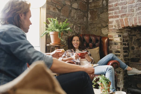 中成人夫妇坐在一家小咖啡店放松身心 他们坐在真皮沙发上 一边聊天一边喝咖啡 — 图库照片