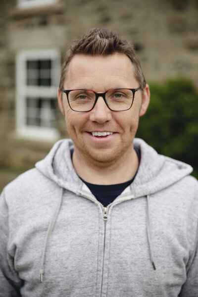 Portrait of a smiling mid adult man looking at the camera.