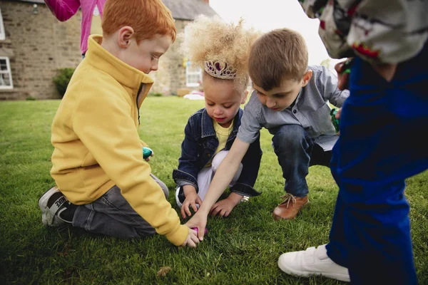 Group Young Children Kneeling Circle Outdoors Share Out Easter Eggs Stock Picture