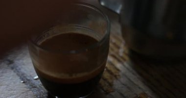 Bir fincan kahve alıp ve içine önce dökülen süt karıştırma unrecognisable bir kişinin yakın çekim görünümü.