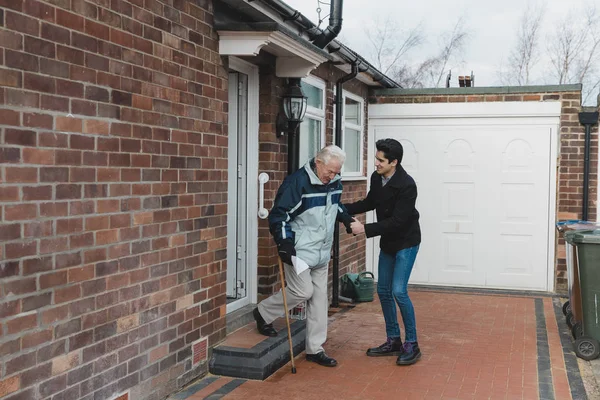 Teenage Boy Helping His Grandfather Out Door Steps His House — Stock Photo, Image