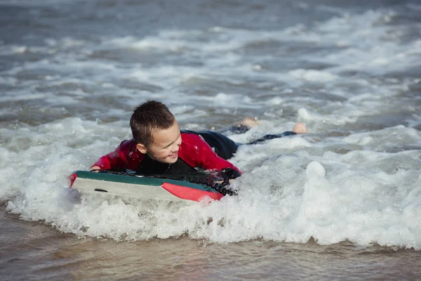 Little Boy Bodyboarding in the Sea — Stock Photo, Image
