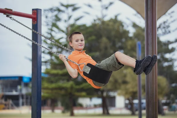 Young Boy Playing on the Swings — Stock Photo, Image