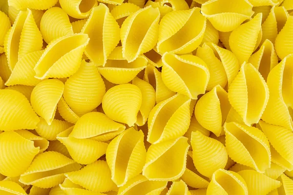 Hintergrund Der Verstreuten Ungekochten Italienischen Conchiglie Nudelschalen — Stockfoto