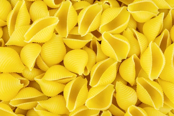 Background Scattered Uncooked Italian Conchiglie Pasta Shells — Stock Photo, Image