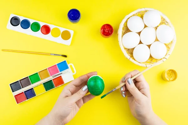 Girl paints eggs