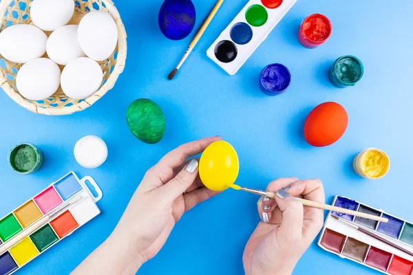 Girl paints eggs