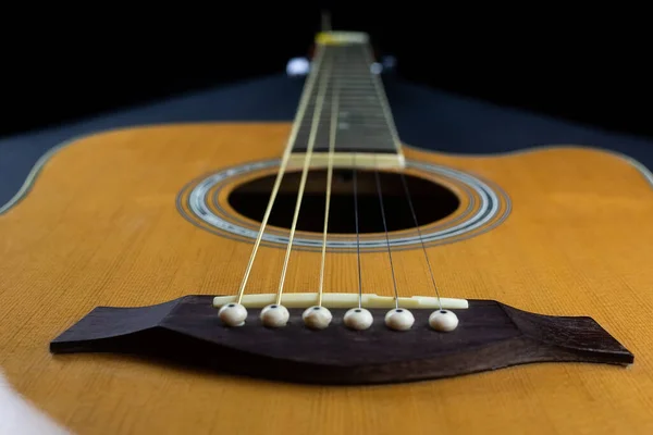 Yellow Guitar Pick Tucked Gold Acoustic Guitar Strings Dark Wood — Photo