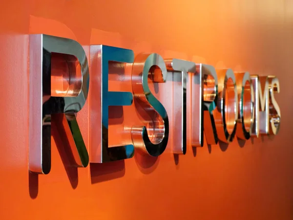 Restrooms Silver Text Orange Wall Perspective View — Stock Photo, Image