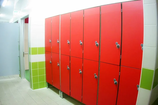 changing or dressing room with red closed lockers