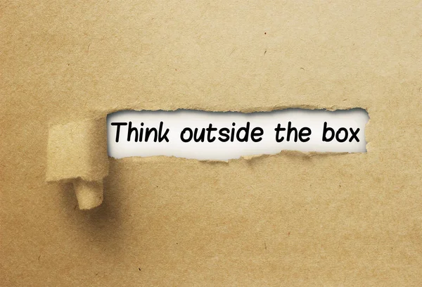 Think outside the box behind ripped curl paper — Stock Photo, Image