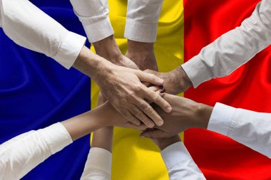Union or Team Hands multcultural people team over romanian flag topview clipart