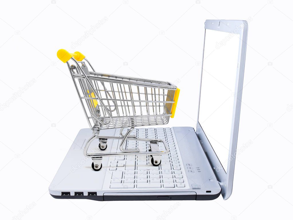 shopping cart and laptop side view isolated on white. Electronic commerce concept