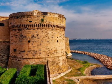 Aragonese castle at sunset in Taranto puglia Italy clipart