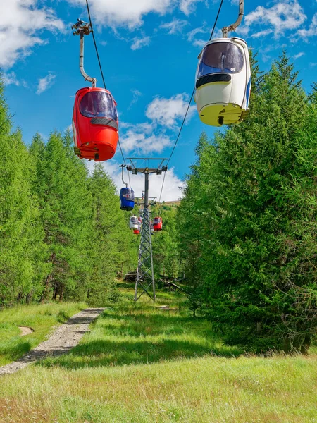 Gondola Lift Going Up Mountain in summer.