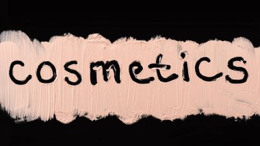 Sıvı temel doku. Siyah arka plan üzerine sıvı krem temel makyaj, yakın çekim. Kozmetik metin