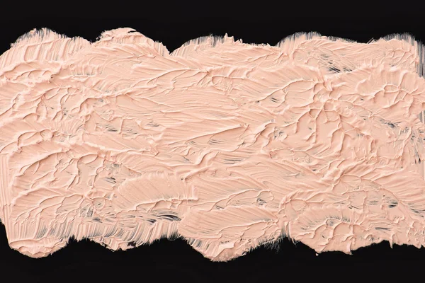 Texture of liquid foundation. Close up of a make up liquid cream foundation on black background