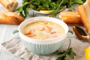 Finnish creamy soup with salmon, potatoes, onions, and carrots  clipart