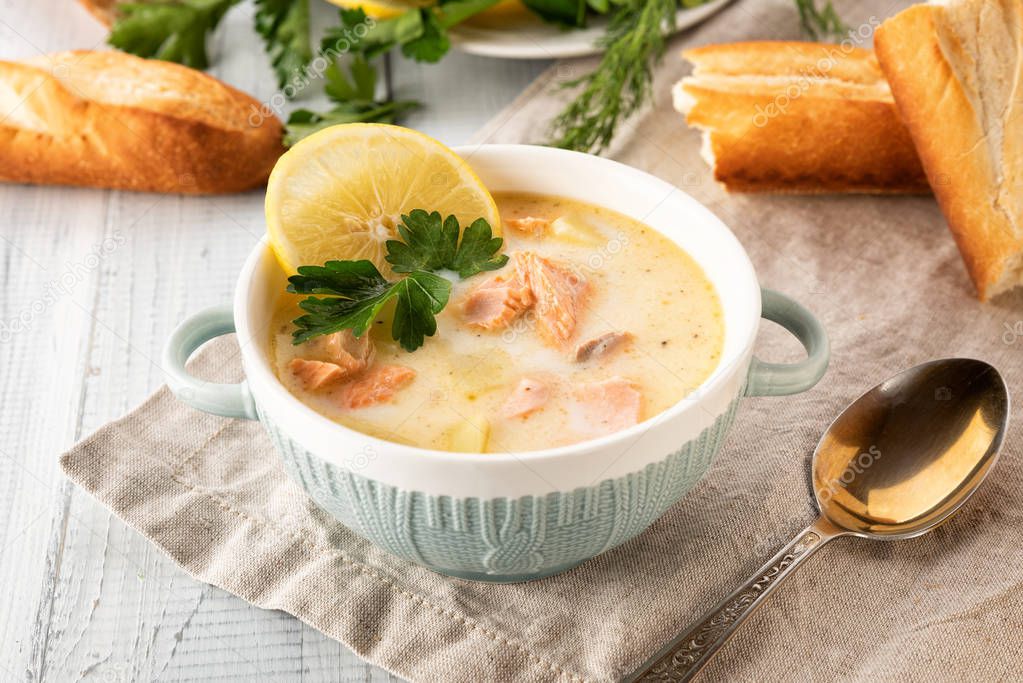 Finnish creamy soup with salmon, potatoes, onions, and carrots 