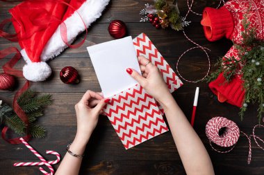 Elinde Noel hediyeleri tutan kırmızı tırnaklı kadın.