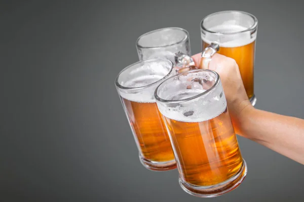 Oktoberfest concept - hand holding glasses with beer — Stock Photo, Image